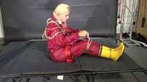 Alice bound and gagged in a nylon Rainsuit