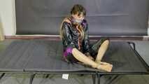 Lana handcuffed and gagged wearing a shiny nylon Windbreaker