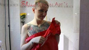 Mara wearing a very old red oldschool shiny nylon rain jacket and a black rain pants taking a shower (Pics)