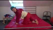 Watching sexy Mara during a photo shooting wearing a sexy red shiny nylon rainpant and an oldschool red/white shiny nylon down jacket posing infront of the camera (Video)