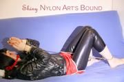 Mara ties and gagges herself with hand cuffs on a sofa wearing a supersexy black Leggings and a shiny nylon shorts and a rain jacket (Pics)