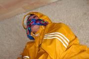 Katharina tied and gagged in a yellow rainsuit
