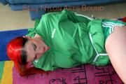 Jill tied and gagged on the floor wearing a hot green shiny nylon shorts and a rain jacket (Pics)