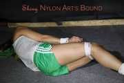 Watching sexy Sandra wearing a sexy green shorts and a white top being tied and gagged on the floor with ropes and a cloth gag (Pics)