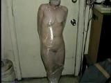 TINY TINA NAKED & MUMMY WRAPPED WITH PLASTIC WRAP & BLACK TAPE (D28-12)