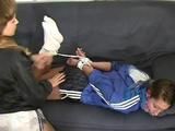 Stella tied and gagged by an archive girl in a black shiny nylon shorts with white stripes and a blue rain jacket (Video)