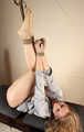 Ballgagged barefoot Albina Rose, balltied on the massage couch, wiggles helplessly