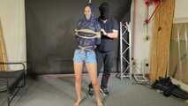 Lena buttplugged, bound and gagged in shiny Shorts and Windbreaker