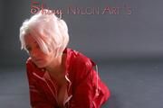 Blonde archive girl posing in a studio wearing a sexy red AGU rainwear combination (Pics)