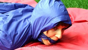 Nicole tied and gagged in shiny nylon rainwear
