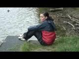 Sexy archive girl dressed with an shiny nylon adidas shorts and puts a rain pants and a rain jacket over it (Video)