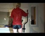 Sonja wearing a darkblue shiny nylon shorts size 3 and a red shiny nylon rain jacket during her workout on the crosstrainer (Video)