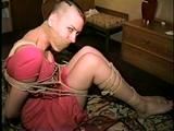 PUNK GIRL MELA IS WRAP TAPE GAGGED, BAREFOOT, TOE-TIED & BALL-TIED ON THE BED (D46-15)