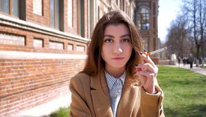 Anastasia is answering the questions while smoking 120mm on public