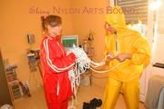 Stella tied, gagged and hooded from Leonie both wearing shiny nylon rainwear (Pics)