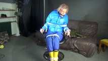 Sexy Pia being tied and gagged with ropes and a cloth gag on a hairdressers chair wearing a sexy blue shiny nylon rainpants and a lightblue downjacket (Video)