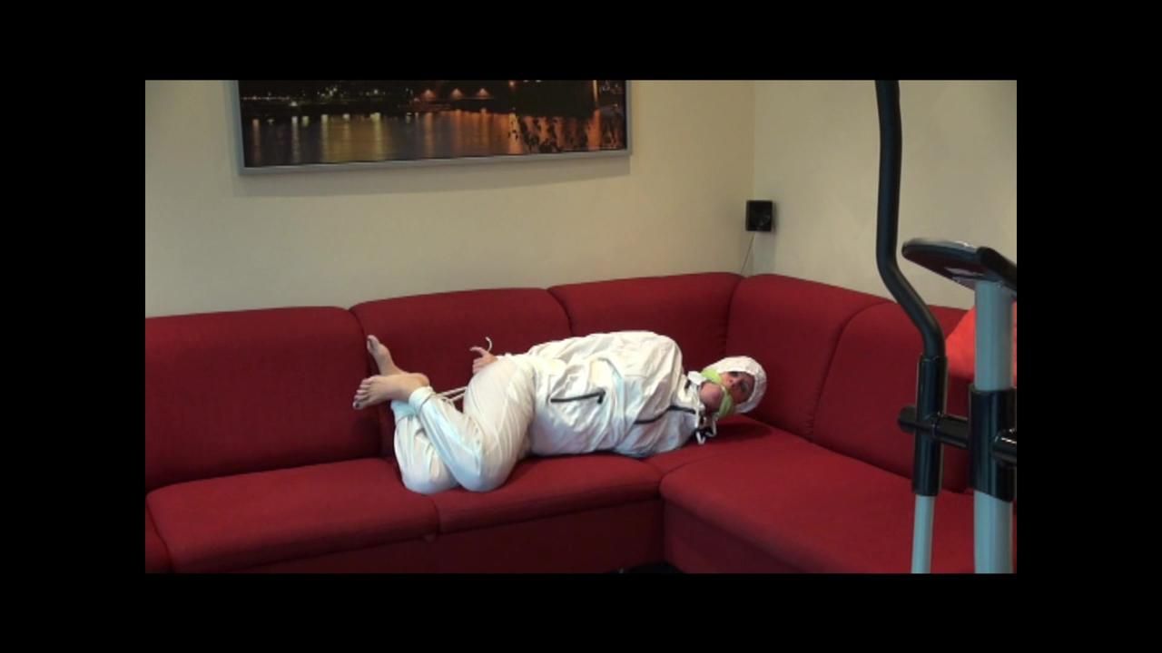 Pia Tied And Gagged On A Sofa Wearing A Shiny White Rainsuit (Video)