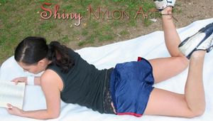 Enni sunbathing on a lake wearing sexy shiny nylon shorts and a top (Pics)