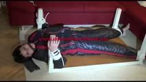 Mara tied and gagged on a bottom-up table wearing a supersexy black/red downwear combination (Video)
