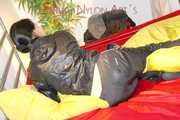 Lucy preparing her bed and enjoys it wearing sexy black rainwear (Pics)