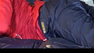 Sonja posing and lolling on bed wearing a sexy blue/red rainwear combination (Video)