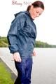 Sexy archive girl wearing a blue rain pant and rain jacket walking on a lake in freetime (Pics)