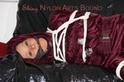 Lucy tied, gagged and hooded on a sofa wearing a sexy darkred downwear combination (Pics)