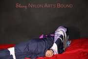 Watching Pia wearing blue/pink shiny nylon rainwear being tied and gagged and hooded with tape and a clothgag (Pics)