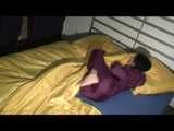 ENNI wearing a sexy purple shiny nylon rain suit lying in bed with yellow shiny nylon cloths lolling and posing (Video)