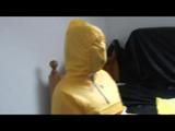 Jill tied and gagged on a chair wearing a yellow rainsuit and coveres with an yellow raincoat with two hoods (Video)