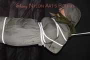 Sexy Sandra being tied and gagged overhead with ropes and a clothgag hodded wearing a sexy rainwear combination (Pics)