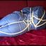 Lucy tied and gagged on the sofa wearing an oldschool blue downsuit (Video)