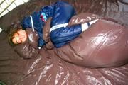 Stella tied and gagged in shiny nylon rainwear