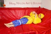 Sonja tied, gagged and hooded on a sofa wearing a sexy blue rain pants and a yellow downwear jacket (Pics)