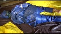 Lucy tied and gagged by herself on a bed wearing sexy AGU shiny nylon rainwear (Video)