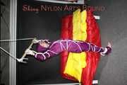 Watching sexy Sonja wearing a supersexy purple shiny nylon rainwear combination being tied and gagged overhead with ropes and a clothgag (Pics)
