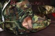 Sexy PIA being tied and gagged with tape and a clothgag on the sofa wearing a camouflage rainsuit and yellow rubber boots (Pics)