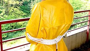 Leonie tied and gagged outdoor wearing shiny yellow rainwear (Pics)