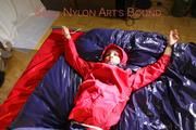 Sonja tied, gagged and hooded on bed with cuffs, chains and a gag wearing a sexy blue shiny nylon rain pants and a red rain jacket (Pics)