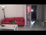 Enni with black shiny nylon shorts and rain pants and a rain jacket over naked skin smoking a cigarette (Video)
