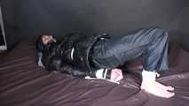 ***SEXY SONJA*** being tied and gagged on a bed with ropes and a clothgag wearing a sexy black shiny nylon down jacket and a black shiny nylon rain pants (Video)