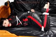 Jill bound and gagged in a shiny nylon skisuit