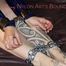 Jill tied and gagged on bed with cuffs and chains wearing a sexy red shiny nylon shorts and a blue shiny nylon rain jacket (Pics)