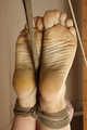 Ballgagged barefoot Albina Rose, balltied on the massage couch, wiggles helplessly