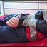 Mara tied with tape, gagged and hooded on bed wearing sexy oldschool shiny nylon rainwear (Video)