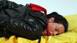 Jessy bound in red shorts and a shiny black jacket
