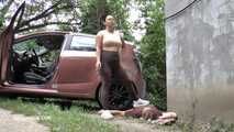 Mistress Jenna stands on the slave with a car while smoking in the slave's mouth B