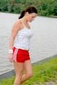 Enni having a good time outdoor wearing sexy shiny nylon shorts and a top posing for the camera (Pics)