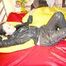 Lucy preparing her bed and enjoys it wearing sexy black rainwear (Pics)