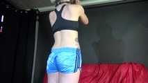 Watching ***NEW MODELL COURTNEY*** wearing a sexy lightblue shiny nylon shorts and a black top being tied and gagged overhead with ropes and a ballgag (Video)